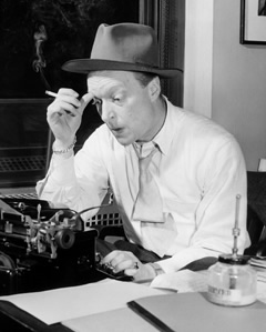 Staats Cotsworth as Casey, Crime Photographer